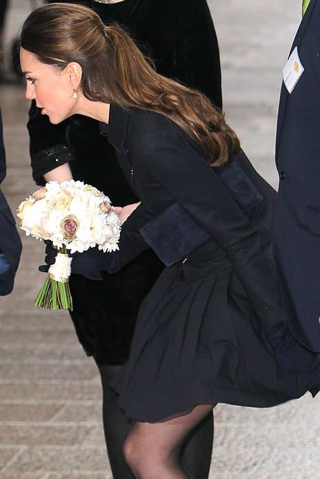 Kate managed to hold down her wind-caught skirt while still focusing on her chat with the school girl