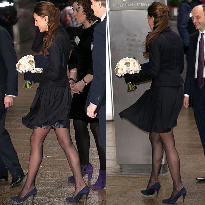 Kate Middleton wearing a blue Max Mara jacket, a blue Orla Kiely skirt, and blue suede pumps at a Place2Be charity event in London