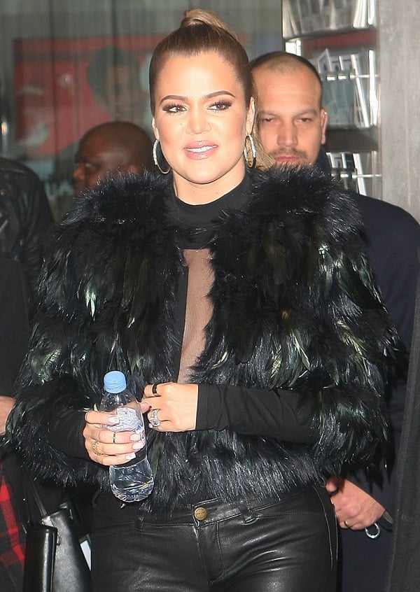Khloe Kardashian wears a Kardashian Kollection crop feather jacket