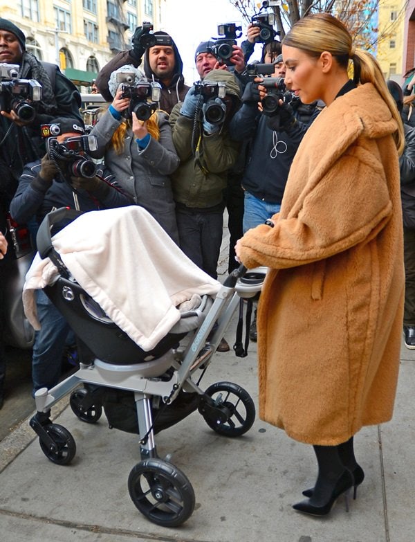 Kim Kardashian wears a Max Mara coat as she leaves Kanye West's apartment