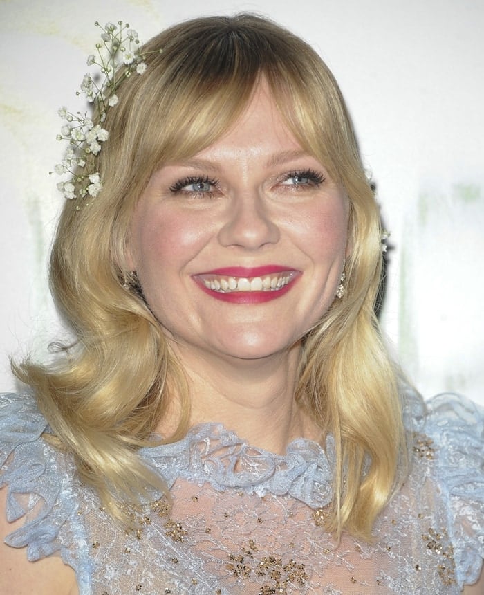 Kirsten Dunst smiles at the Los Angeles premiere of her new movie Woodshock