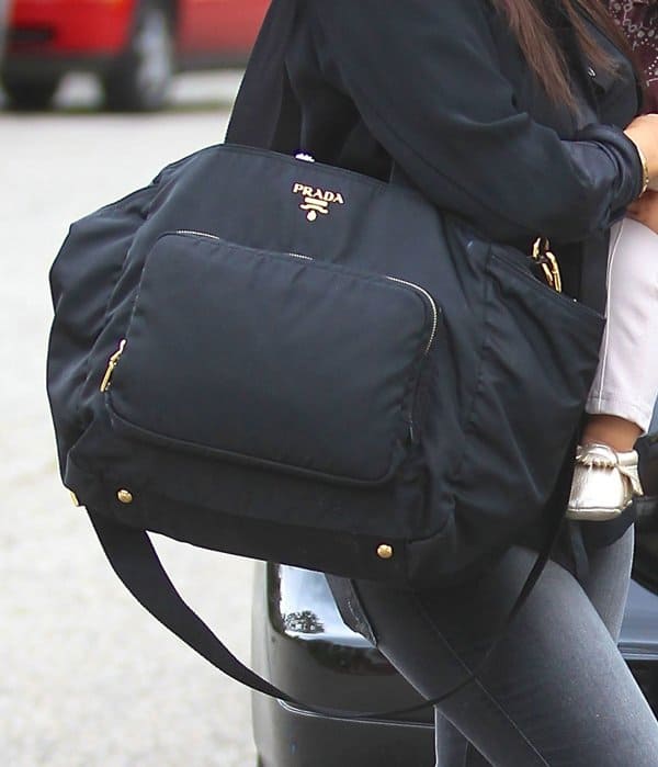 This Prada diaper bag that Kourtney is toting costs over $1,000