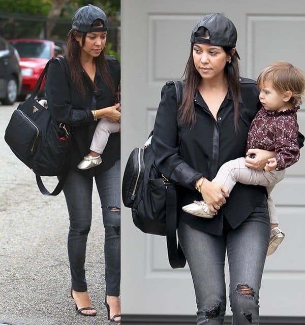 Kourtney was in tattered jeans with a backward cap