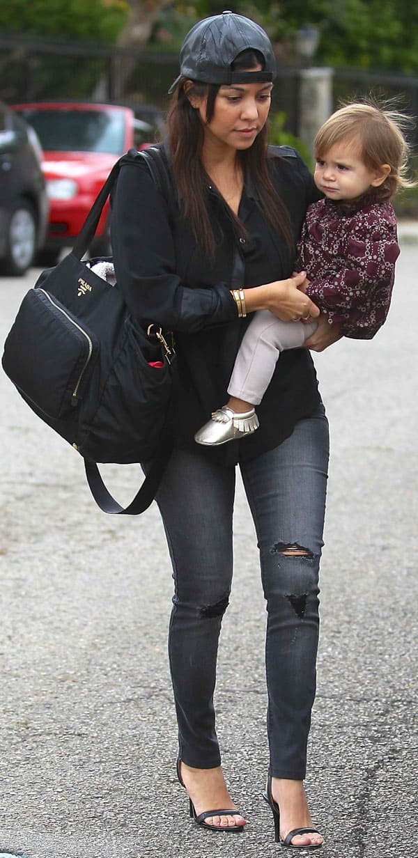 Kourtney Kardashian wears ripped gray jeans while taking her daughter, Penelope Disick, to a baby class