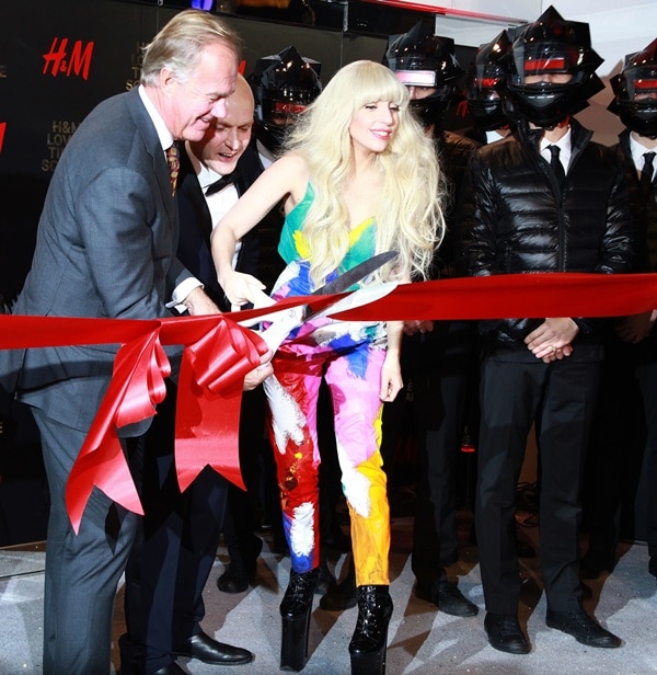 Lady Gaga cuts the ribbon to open the new H&M store while wearing a Kerin Rose Gold jumpsuit