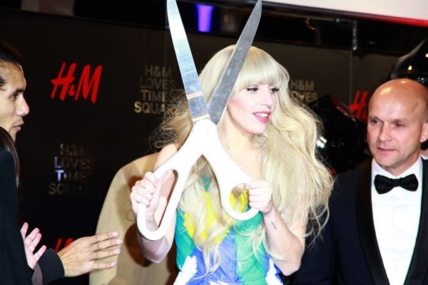 Lady Gaga holds a giant pair of scissors for the opening of the new H&M store in Times Square