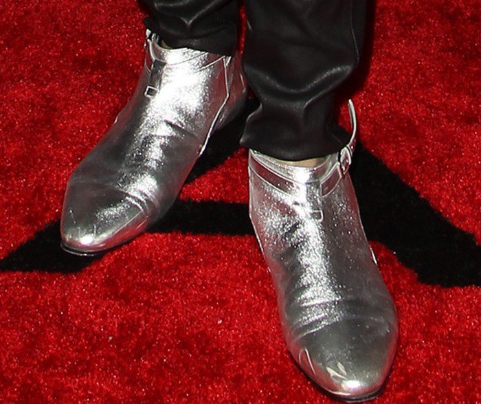 Lenny Kravitz finishes his red carpet ensemble with a pair of silver Saint Laurent boots on his feet