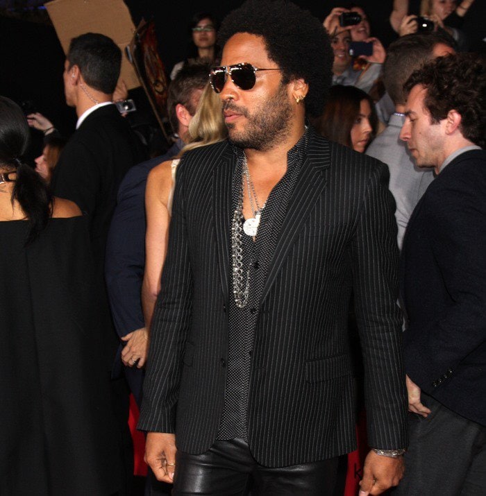 Lenny Kravitz wears a pinstripe jacket and dark aviators on the red carpet