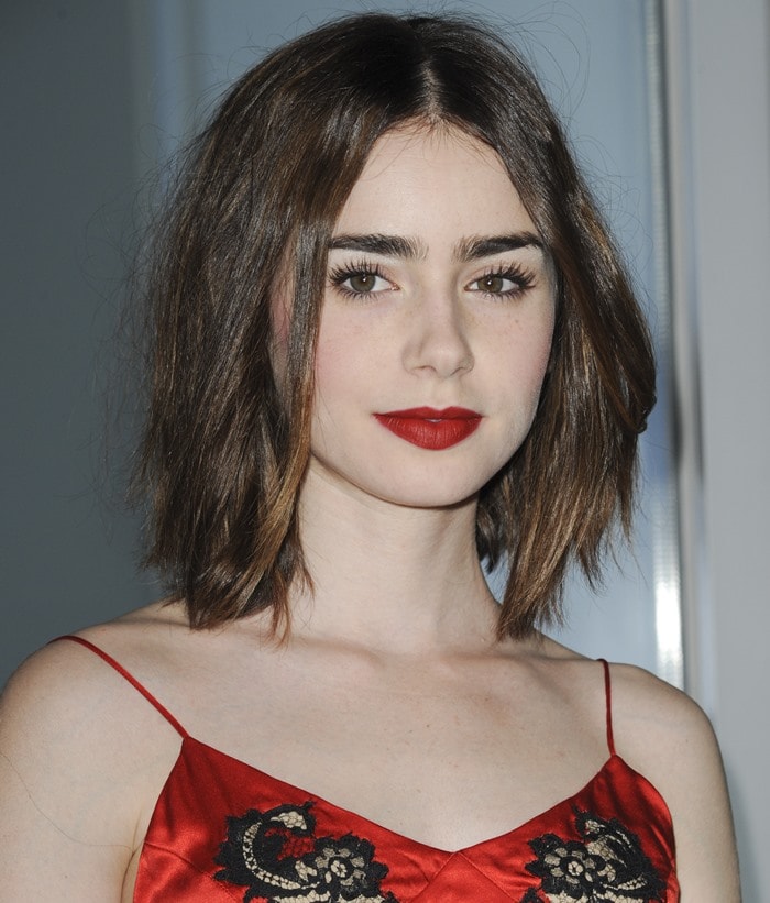 Lily Collins with short hair and vampy red lips