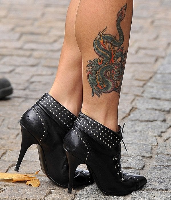 Mel C showing off the colorful, ornate dragon tattoo on her right leg