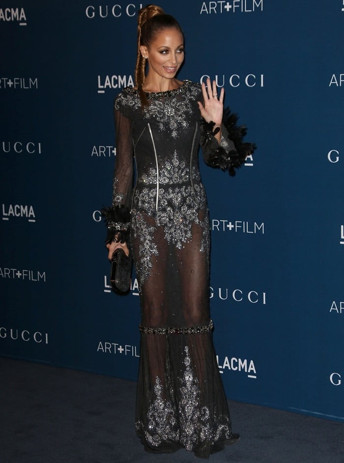 Nicole Richie shows off her underwear in a sheer dress by Dolce & Gabbana featuring silver beading and feather-and-bedazzled cuffs