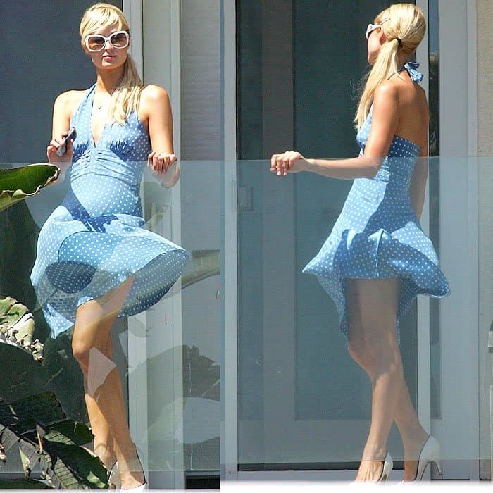 Paris Hilton's playful polka dot dress catches the wind as she enjoys a breezy day on the balcony of her Malibu beach house