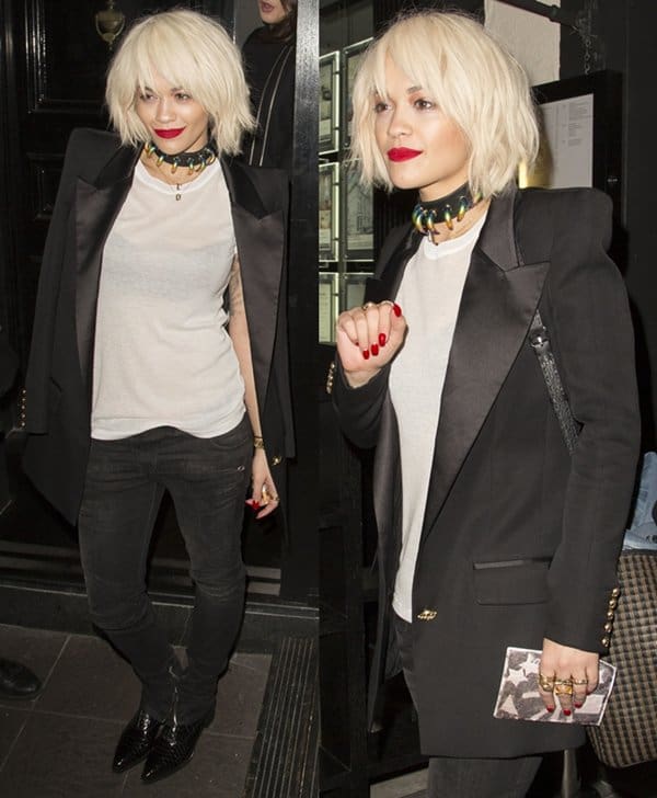 Rita Ora showcasing her fierce style with a bold claw choker from Yoon Ahn's Ambush Design, paired with a sleek black blazer, white tee, and skinny jeans at Kyle De'Volle's birthday celebration in London