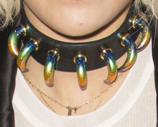 Rita Ora's bold dog collar necklace featuring multicolored fang adornments, adding a fierce and edgy touch to her ensemble