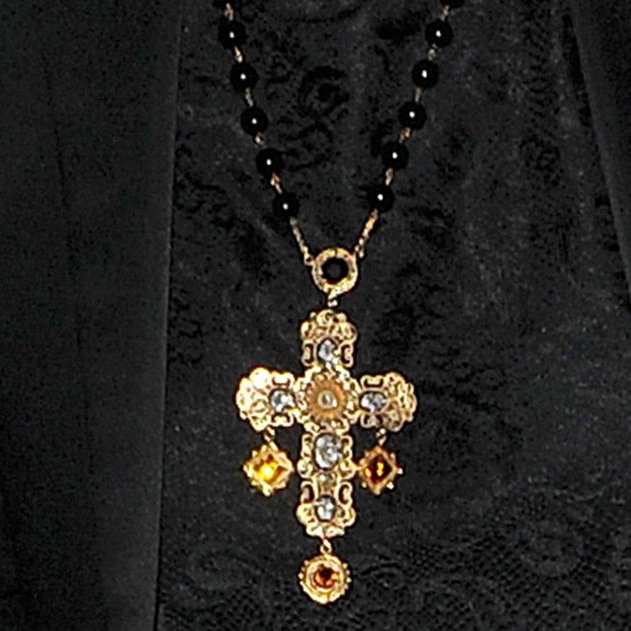 Rita Ora star sported an all black ensemble that was punctuated by a bold rosary necklace with an intricately styled golden cross