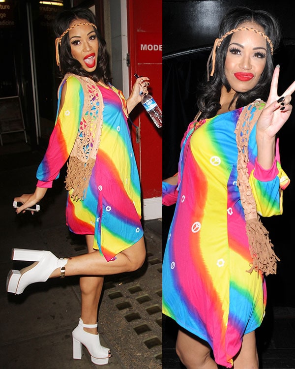 Sarah-Jane Crawford embraced the '70s theme in a vibrant rainbow mini dress, accessorized with a fringed vest, a headband, and bold white platform booties
