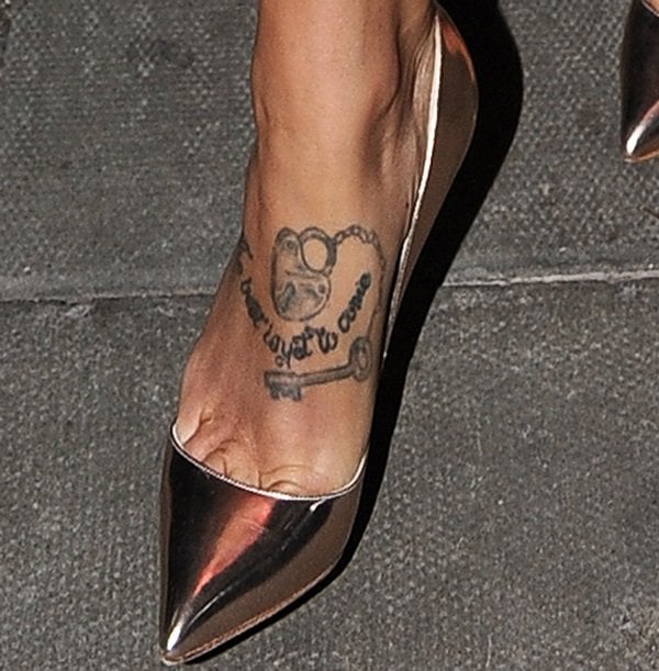 Tamara Ecclestone showing off her foot tattoo that says ‘The Best is yet to Come’