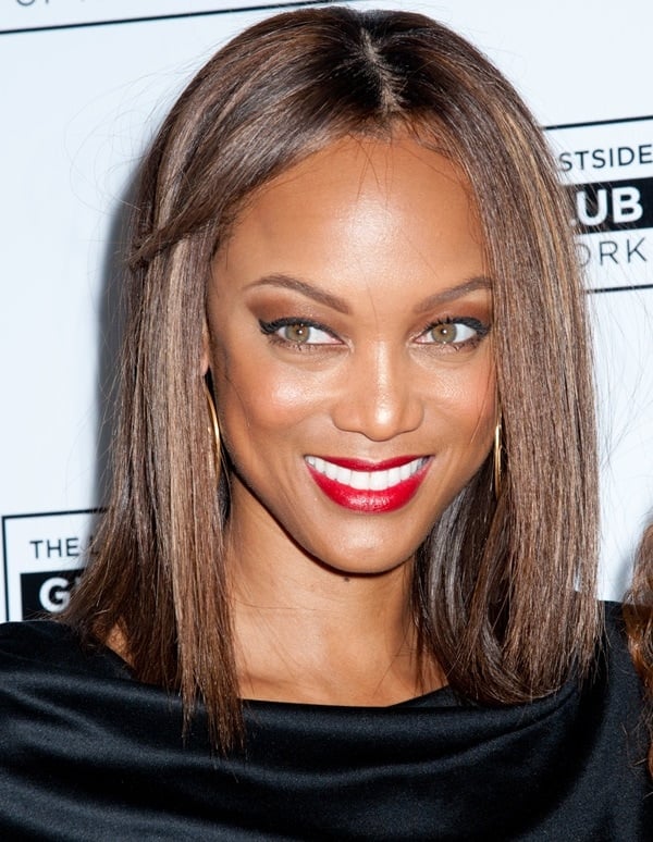 Tyra Banks center parts her hair at the Lower East Side Girls Club Grand Opening Gala