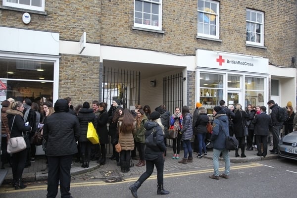 A line of shoppers stands outside the British Red Cross