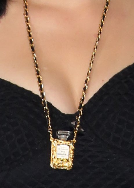 Close-up of the Chanel No. 5 long necklace worn by Katy Perry