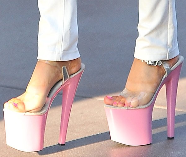 Courtney wears stripper heels with pink platforms