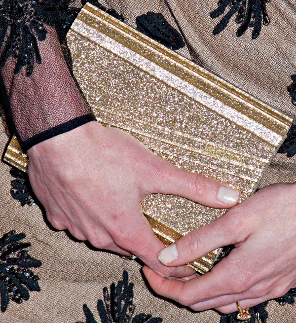 Hilary Rhoda carried a gold clutch from Jimmy Choo