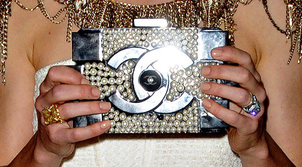 Jessica Biel shows off both her Chanel clutch and a collection of cocktail rings