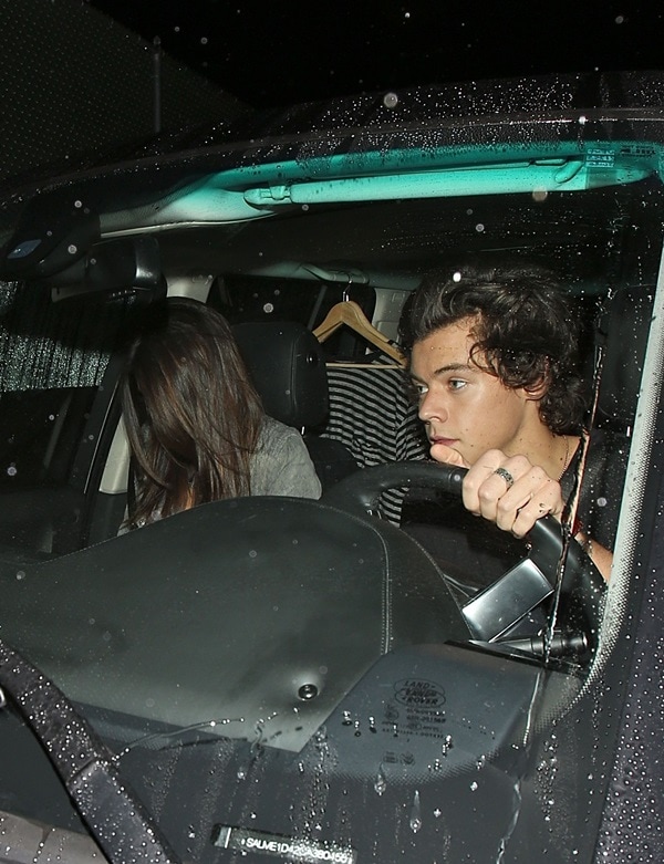 Kendall Jenner hides her face behind her hair as she and Harry Styles leave a restaurant after a dinner date, November 20, 2013 