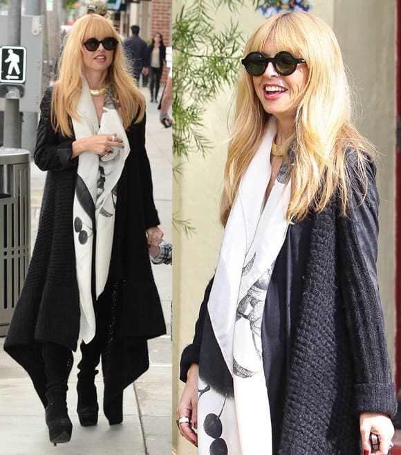 Rachel Zoe wearing a long knitted coat, black boots, and a long white scarf in Beverly Hills
