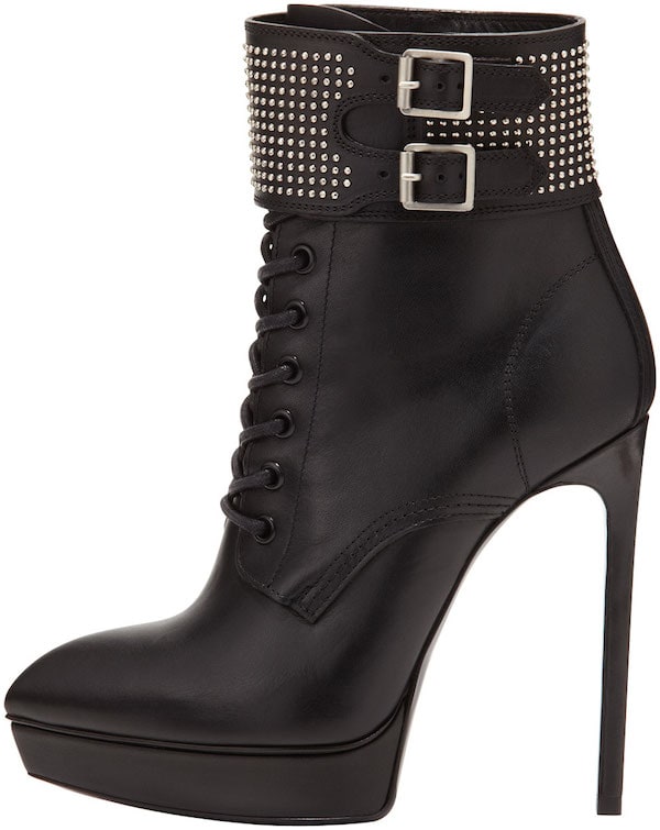 These platform boots from Saint Laurent feature studded cuffs, double buckles, covered heels, pointed toes, lace-up fronts, and matte nappa leather