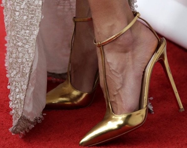 Alessandra Ambrosio showing off her feet in metallic-gold t-strap T-Piga pumps