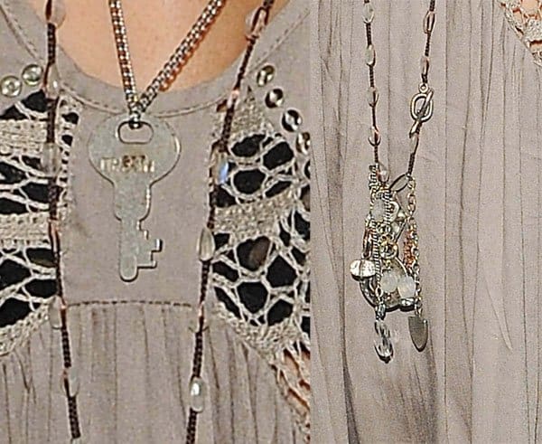 Ashley Tisdale accessorized her outfit with layered necklaces, including a distinctive key pendant and an array of charms