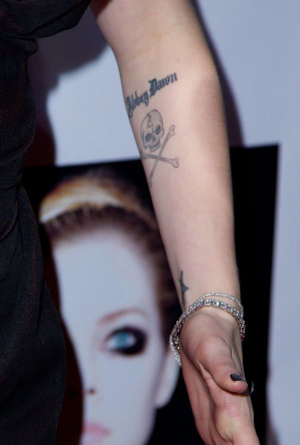 Avril Lavigne showing off the skull and crossbones tattoo below her “Abbey Dawn” ink