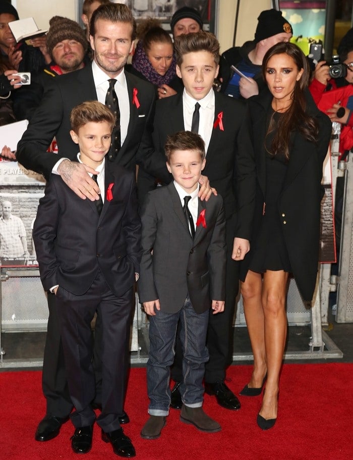 Victoria Beckham stuns in a chic black mini dress and coat, while the entire Beckham family coordinates in elegant suits
