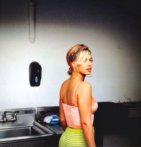 Beyonce wearing a sunburst print bustier by Harlyn with a lime green pencil skirt