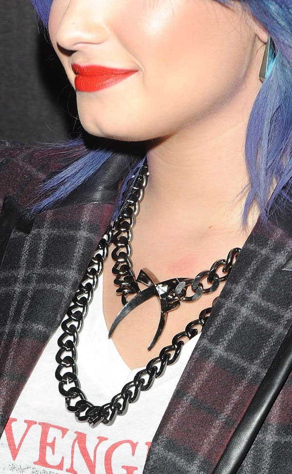 Demi Lovato accessorized with a cross tusk necklace from Luv AJ at the event