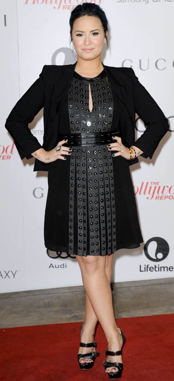 Demi Lovato strikes a confident pose, showcasing her edgy black studded dress paired with a sleek black blazer and stylish Christian Louboutin 'Ambertina' heels at The Hollywood Reporter's Women in Entertainment Breakfast