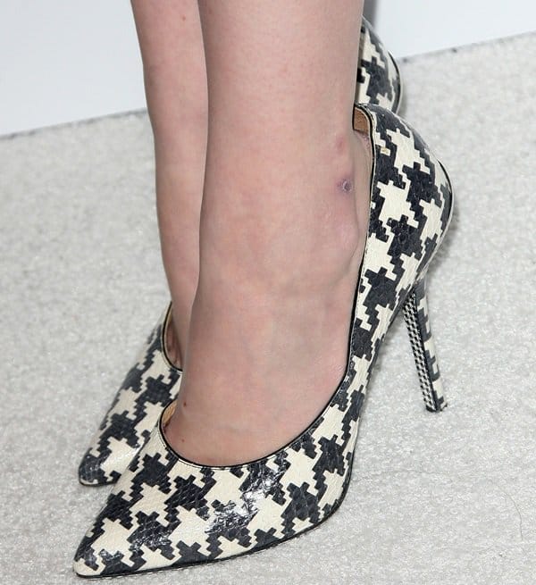 Emma Stone's look is completed with striking houndstooth-printed Salvatore Ferragamo shoes