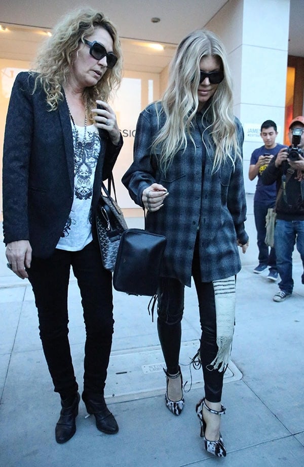 Fergie wears her hair down as she shops with a friend at the James Perse store