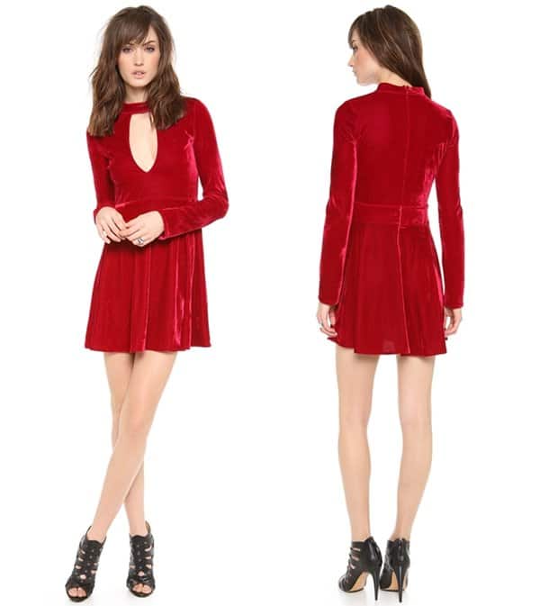 A cutout bodice under a high collar lends allure to this ruby red velvet dress