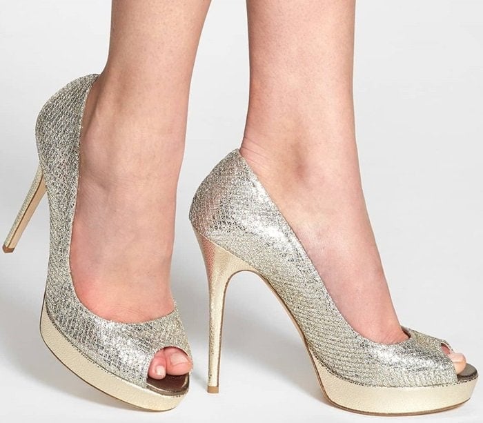 Glittering, textured fabric styles a peep-toe pump lifted by a lofty wrapped heel and platform