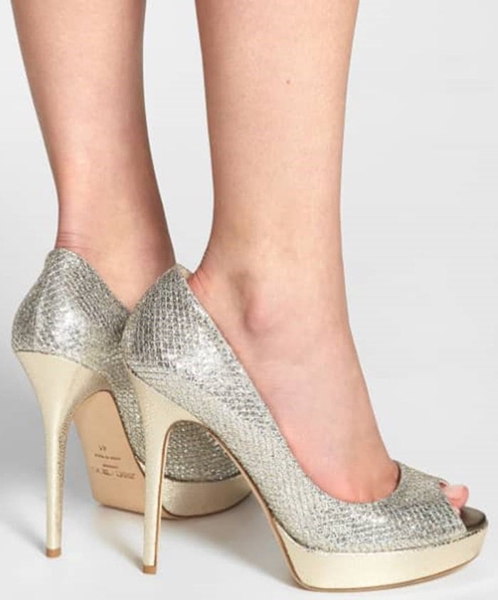 Glittering, textured fabric styles a peep-toe pump lifted by a lofty wrapped heel and platform