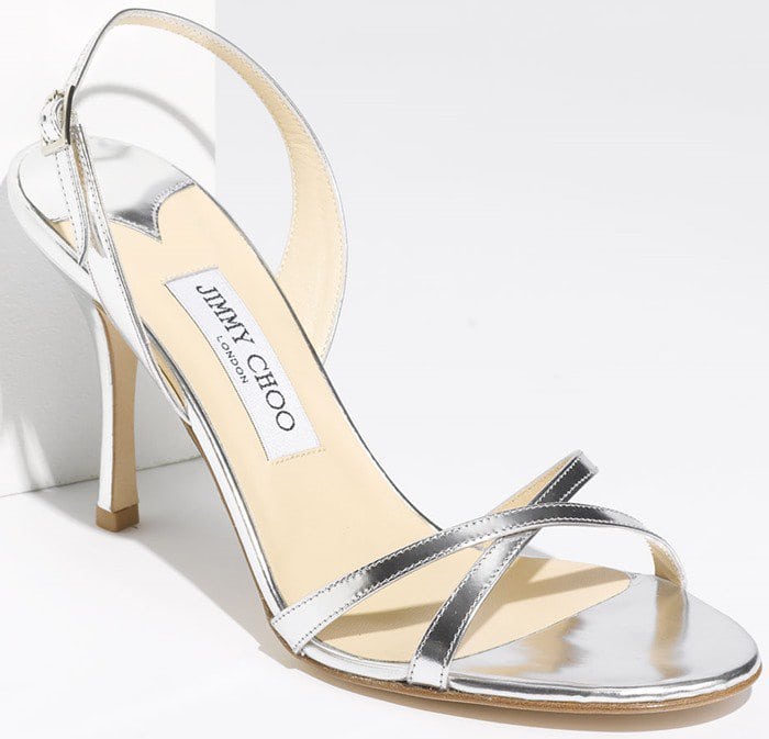 Glossy patent leather enhances the sleek, breezy design of a wonderfully versatile sandal set on a classic high heel.