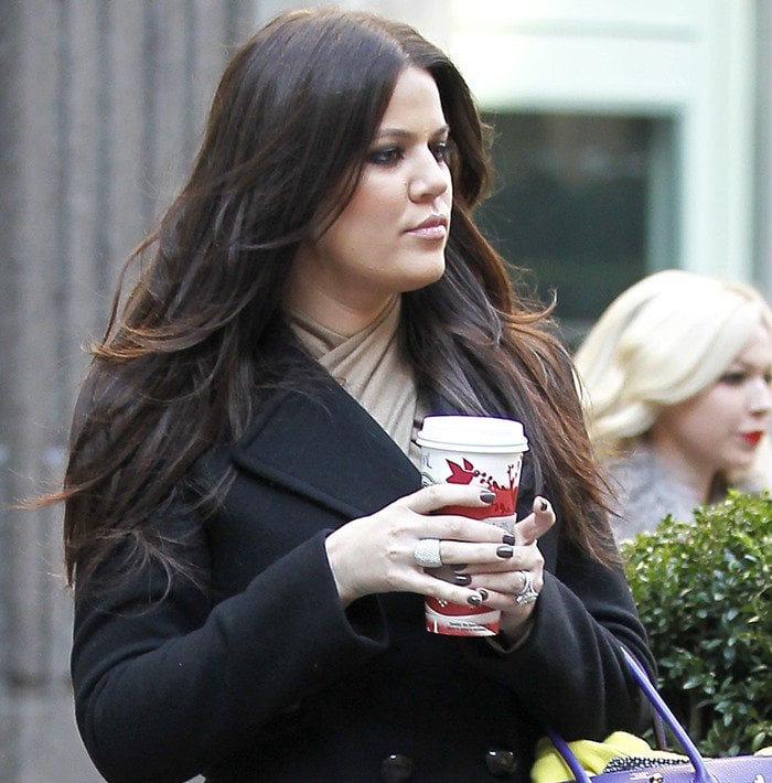 Khloe Kardashian wears a chic black peacoat dress in New York