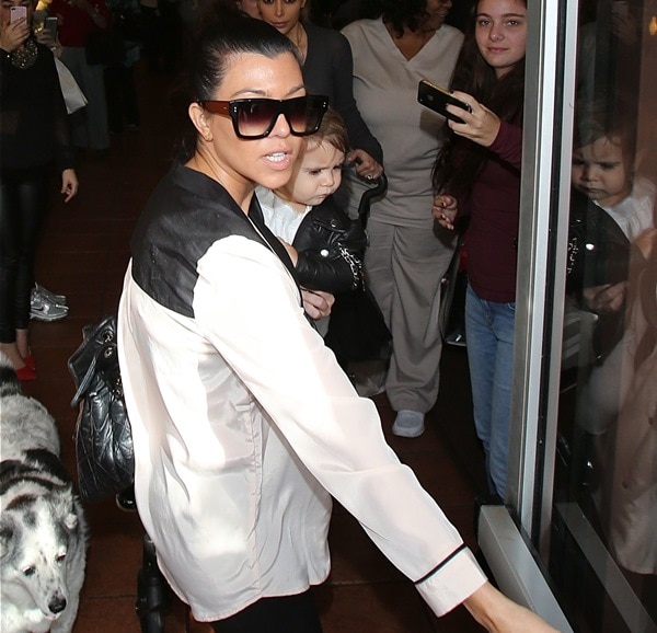 Kourtney Kardashian looked really chic in a tuxedo top and leather pants