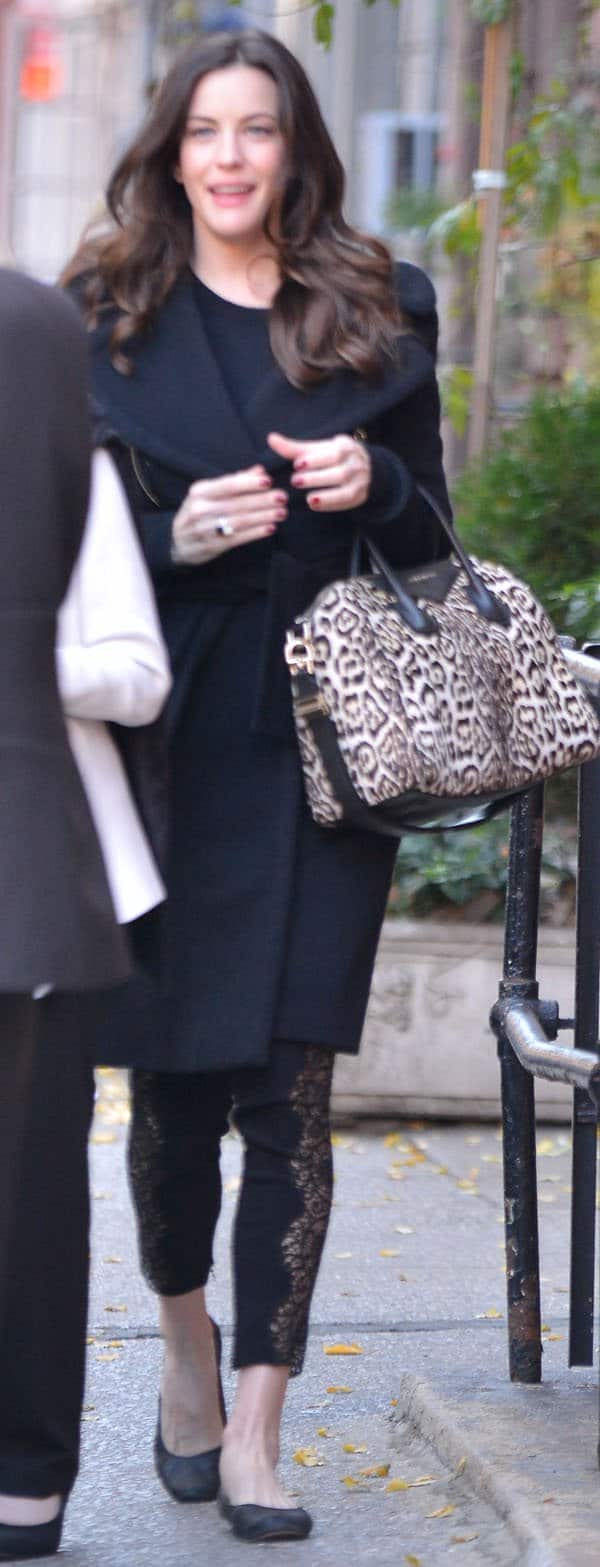Liv Tyler wearing Stella McCartney lace-paneled leggings and a bulky gray coat
