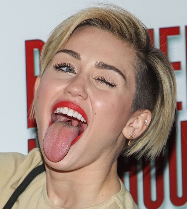 Miley Cyrus shows off her tongue and short hair at the grand opening of "Britney: Piece of Me"