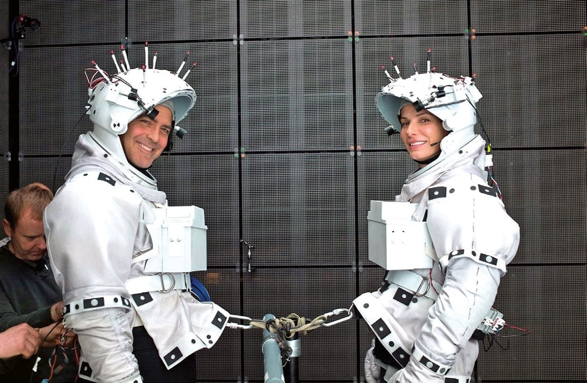 Sandra Bullock as Dr. Ryan Stone and George Clooney as Lieutenant Matt Kowalski on the set of Gravity, which was filmed between May 14, 2011, and July 6, 2011