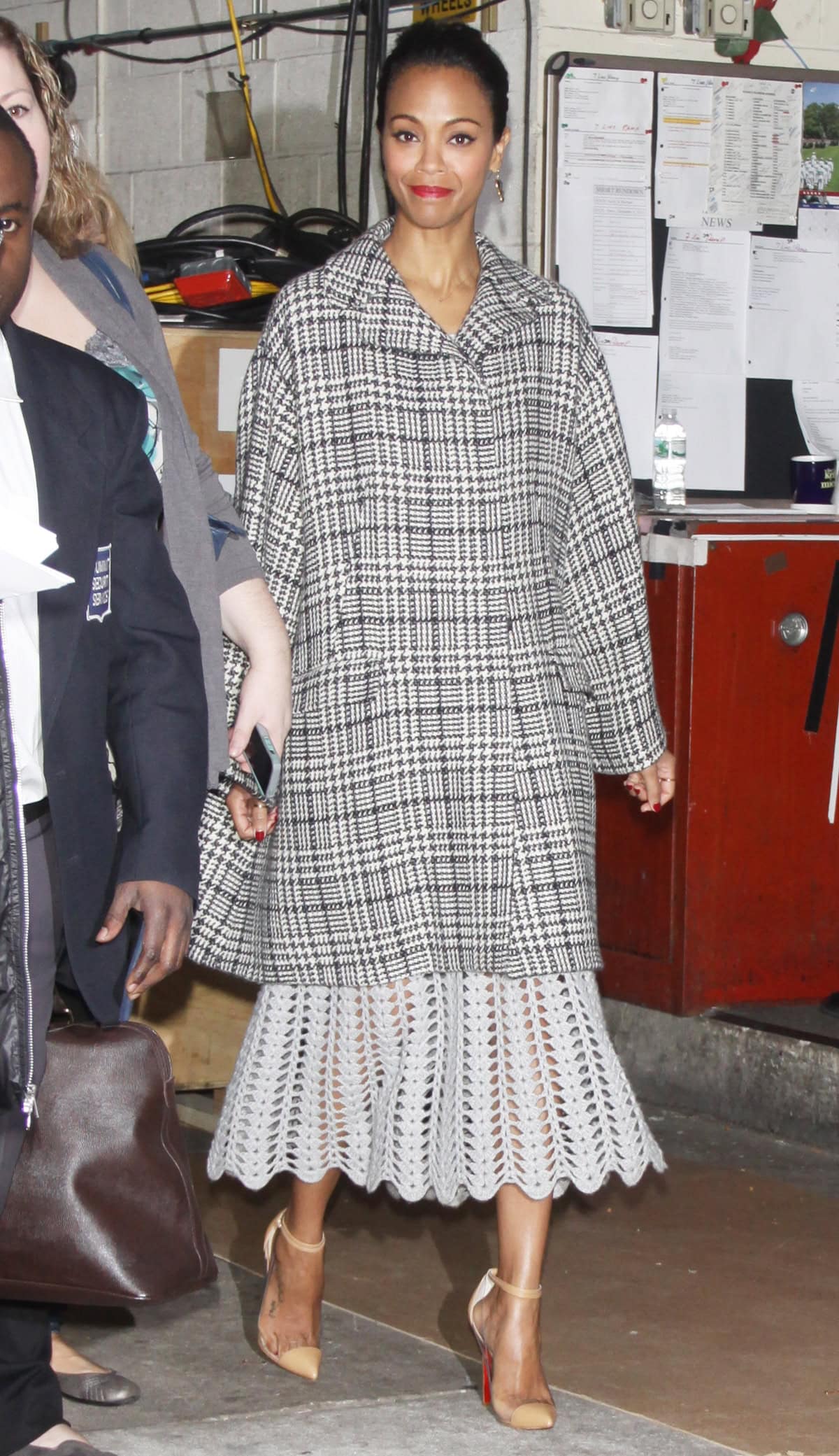 Zoe Saldaña exits ABC studios in New York City wearing Melinda Maria earrings and a Dolce & Gabbana coat after promoting her new movie, "Out of the Furnace," on Live! with Kelly & Michael on December 5, 2013