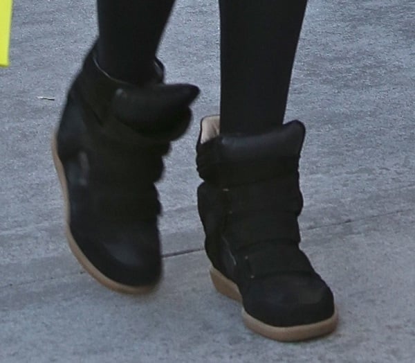 Ashley Tisdale wears a pair of black Isabel Marant wedge sneakers